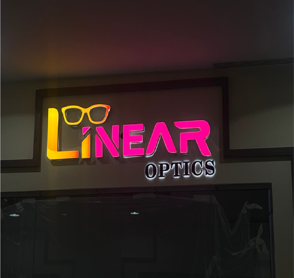 An indoor and outdoor signage display featuring optical-related designs and graphics. The signs are strategically placed to attract attention and communicate information about optical services or products.